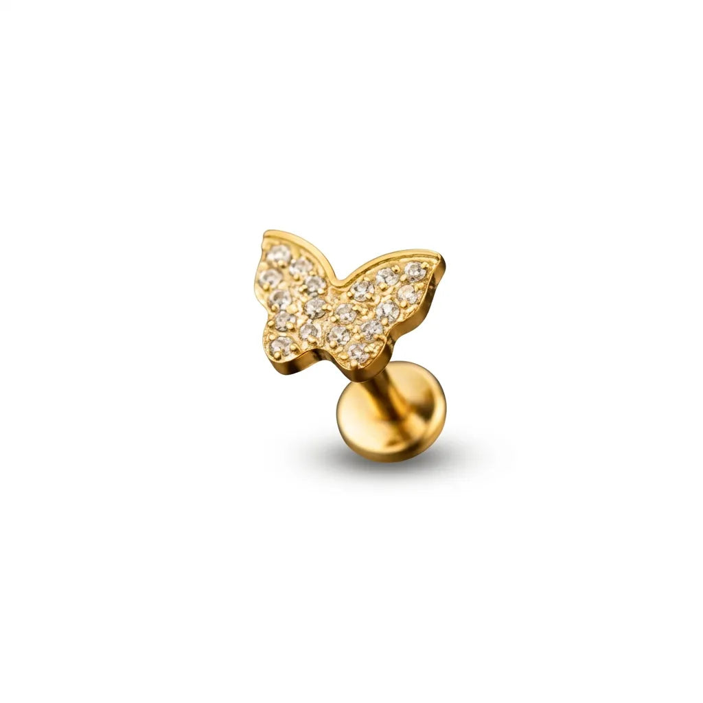 Gold butterfly tragus earring on a white background
