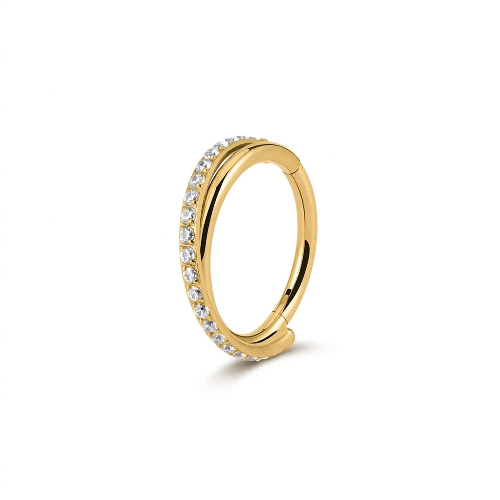 Gold ring with embedded diamonds on a white background