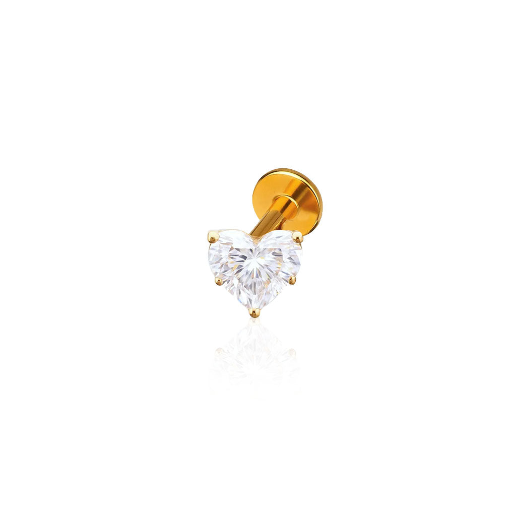 Gold earring with a heart-shaped clear gemstone on a white background