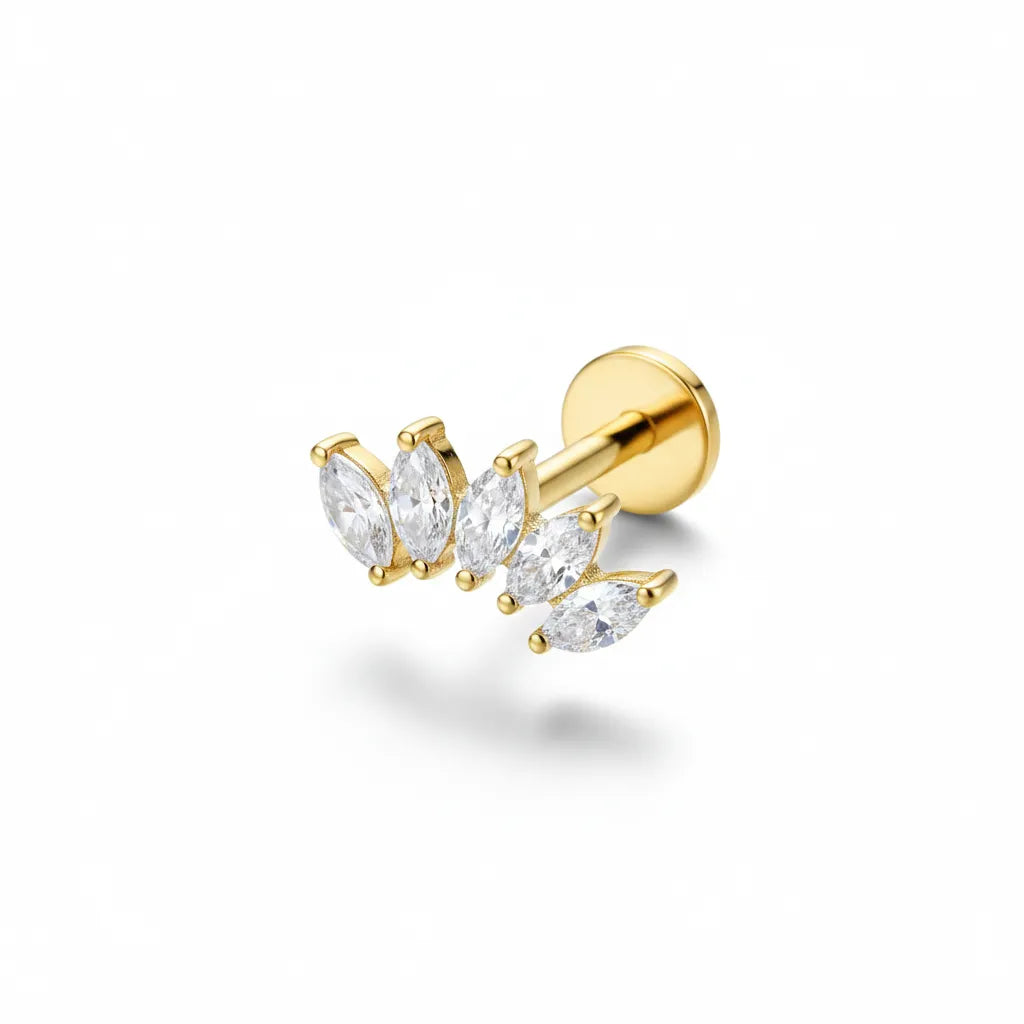Gold earring with clear gemstones on a white background