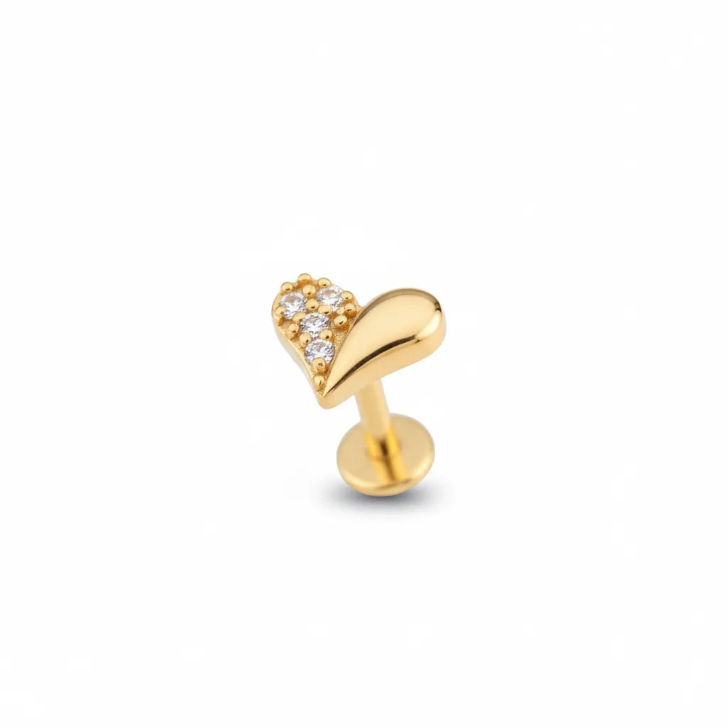 Gold heart-shaped earring with clear stones on a white background