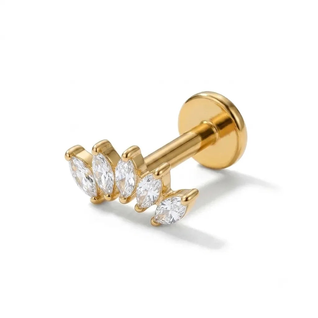 Gold earring with clear gemstones on a white background