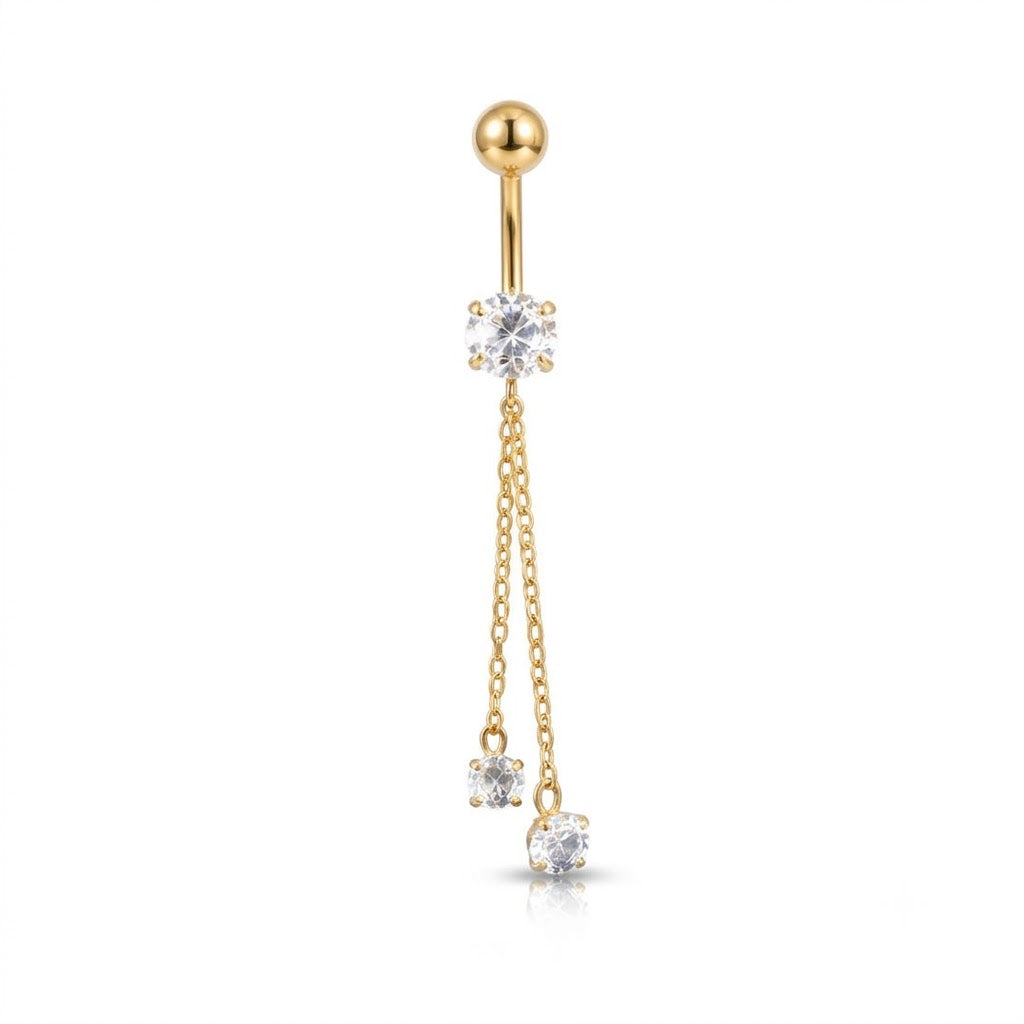 A gold-plated navel piercing barbell featuring a round ball top, a central prong-set clear gemstone, and two dangling chain drops ending in smaller clear gemstones, shown on a plain white background.