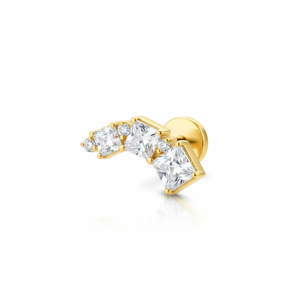 Gold earring with clear gemstones on a white background