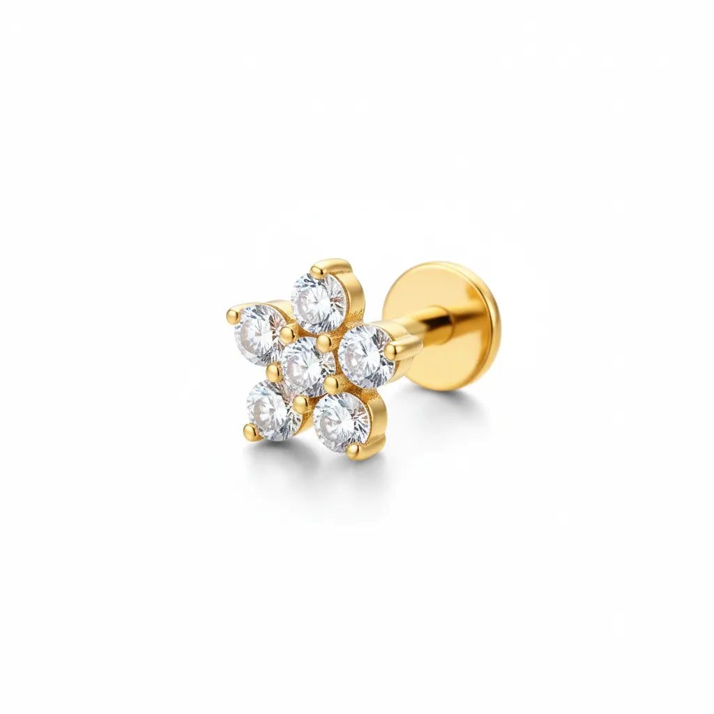 Gold earring with clear gemstones on a white background
