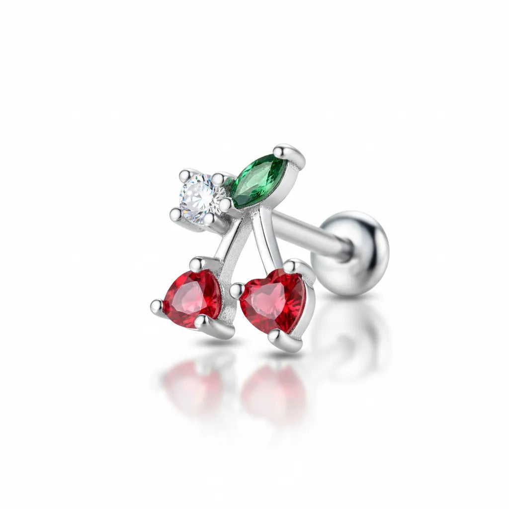 Silver earring with red and green gemstones on a white background