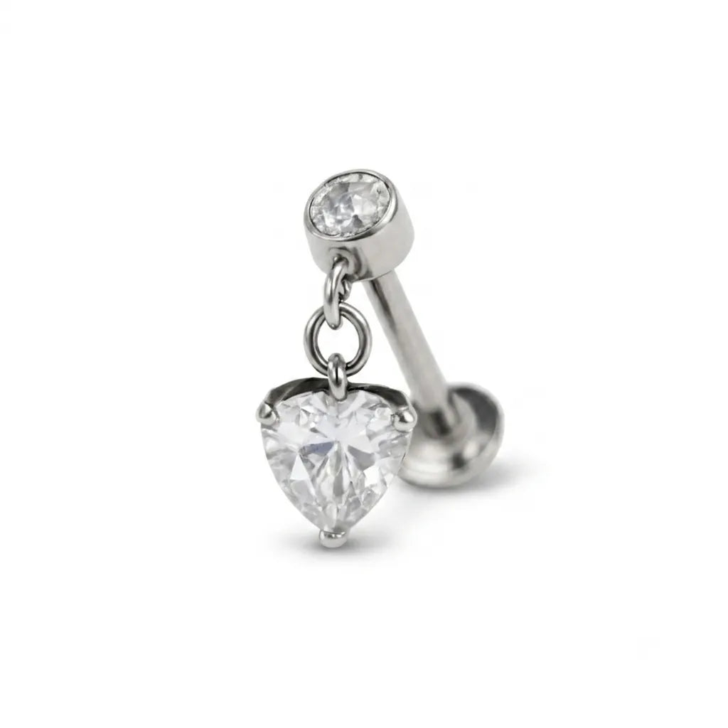 Silver earring with heart-shaped and round clear gemstones on a white background