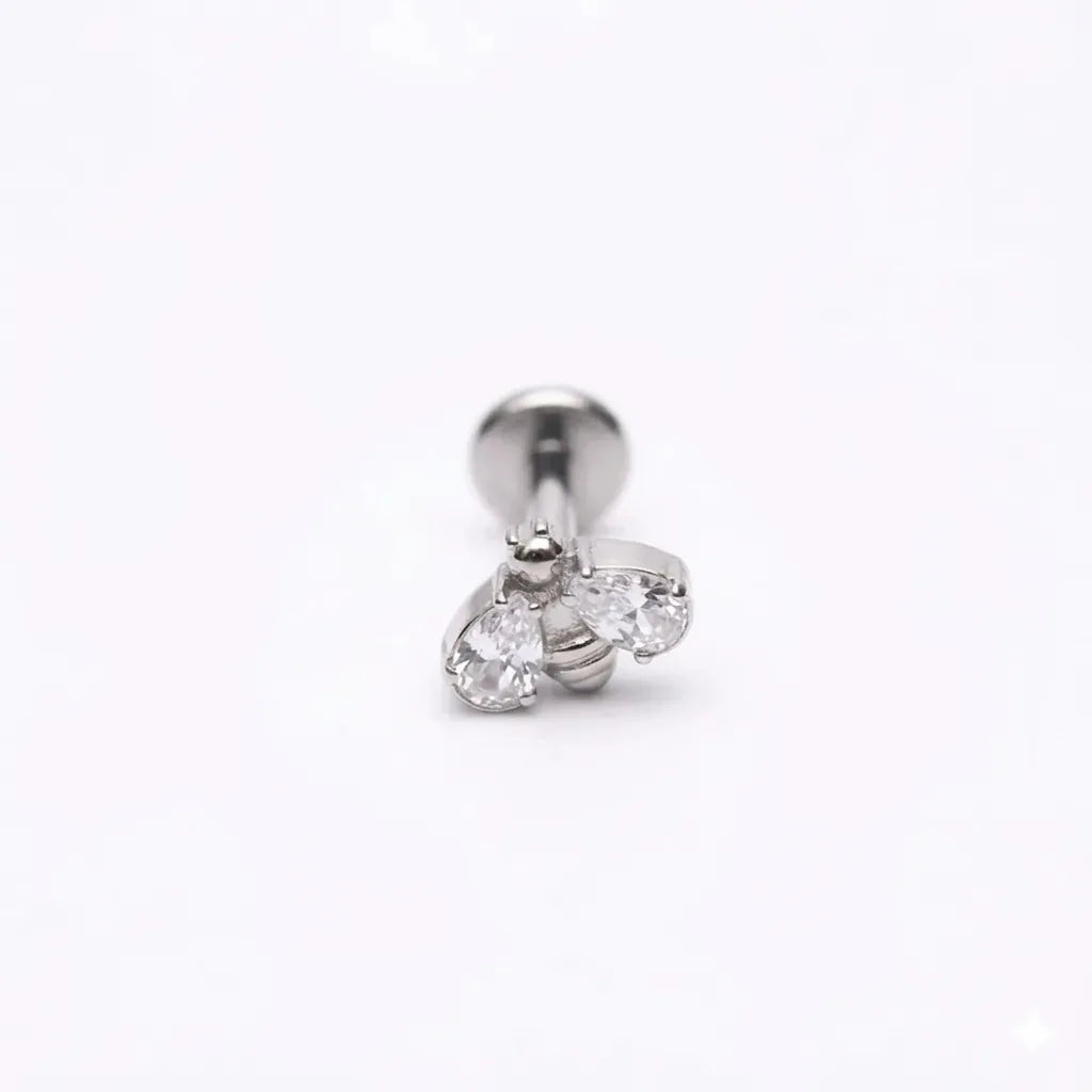 Silver earring with clear gemstones on a white background