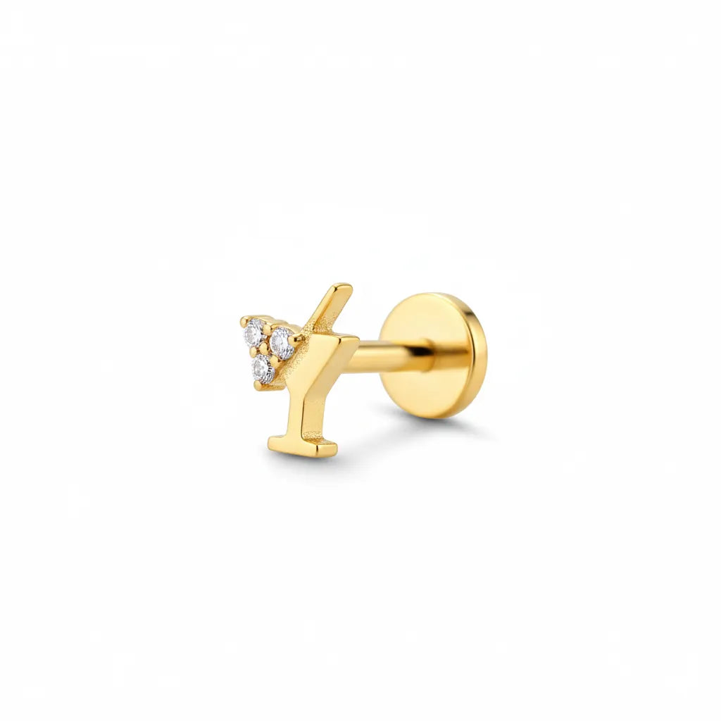 Gold earring with small diamonds on a white background