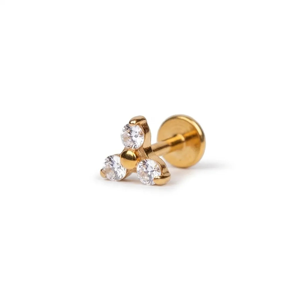 Gold earrings with clear gemstones on a white background
