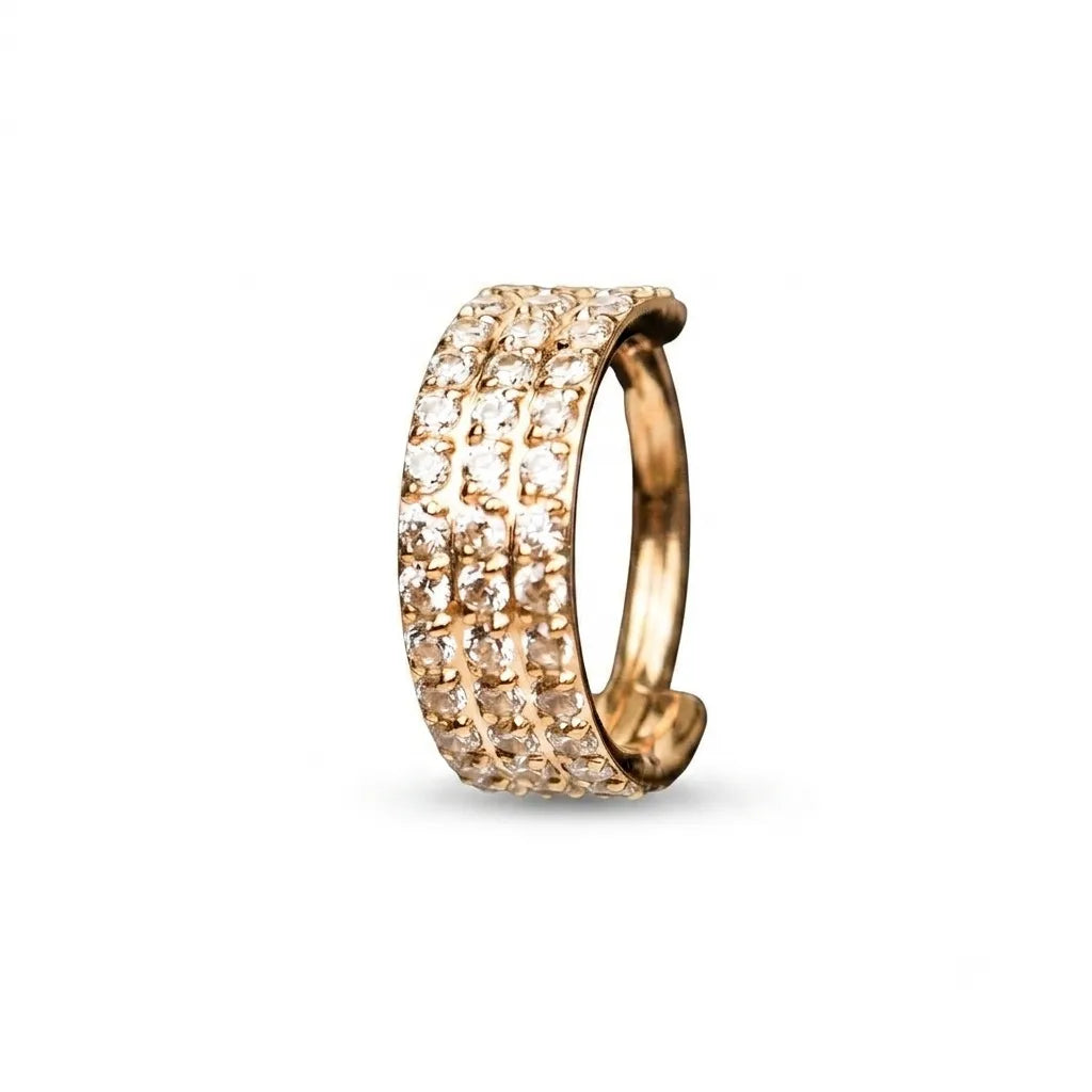 A rose gold huggie ring featuring three rows of pave-set clear cubic zirconia stones, shown on a clean white background.