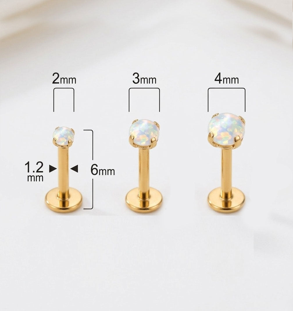 Three gold lip rings with gemstones and their dimensions on a white background