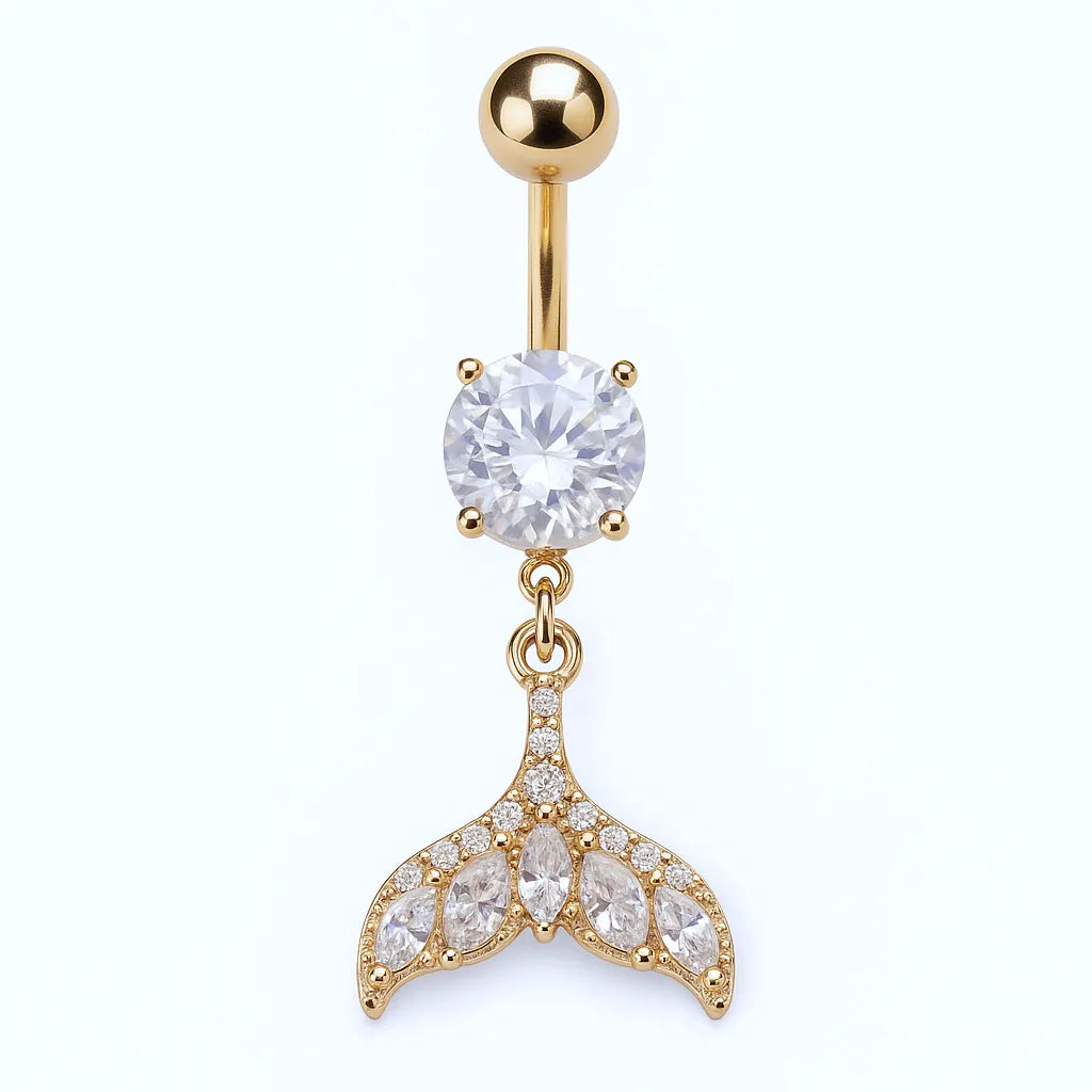 A gold-plated surgical steel belly piercing with a crystal tail design.