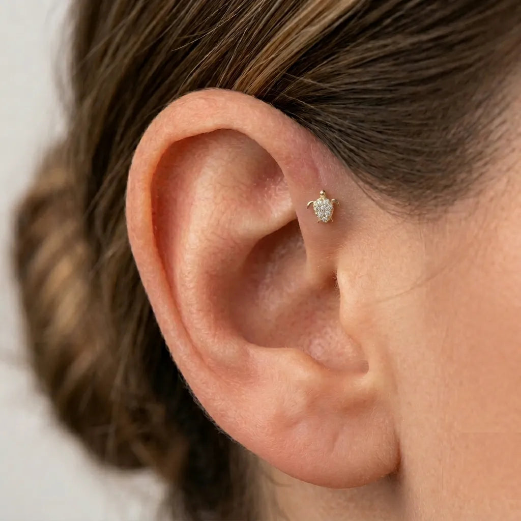 Close-up of an ear with a diamond earring on a neutral background
