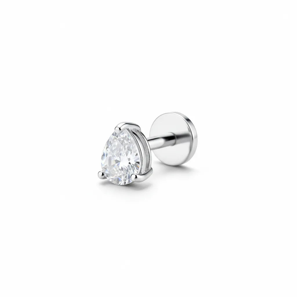 Silver titanium tear drop gem tragus piercing with crystal teardrop top on white background