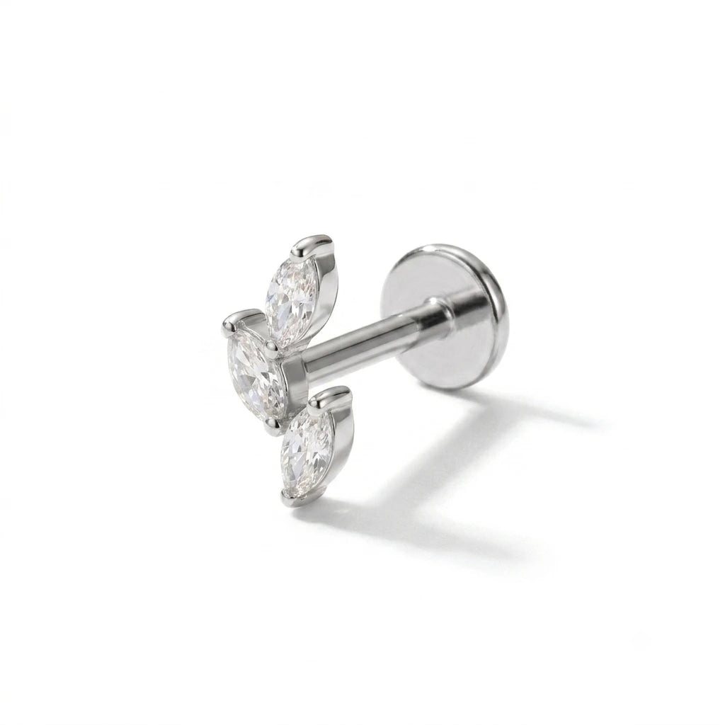 Pair of silver earrings with clear gemstones on a white background