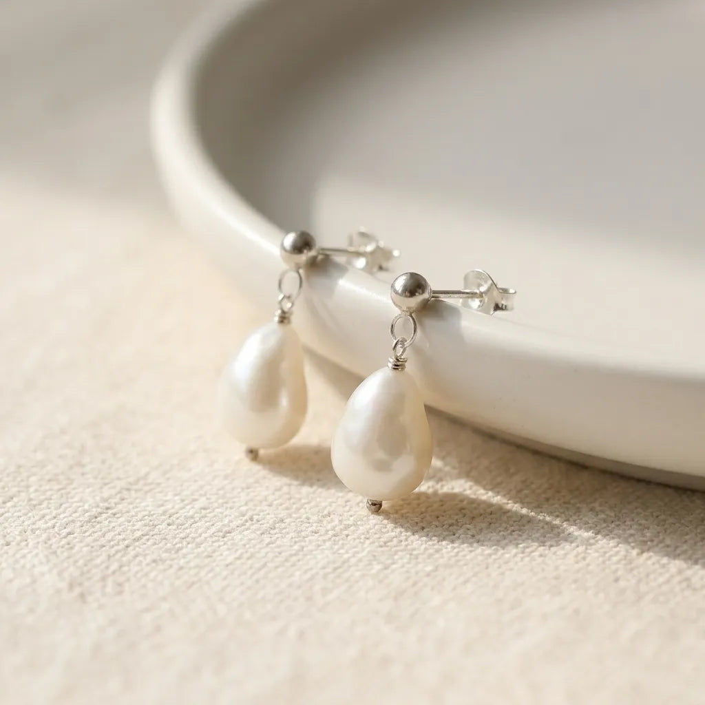 Vita Perlata silver baroque pearl drop earrings flatlay on linen background