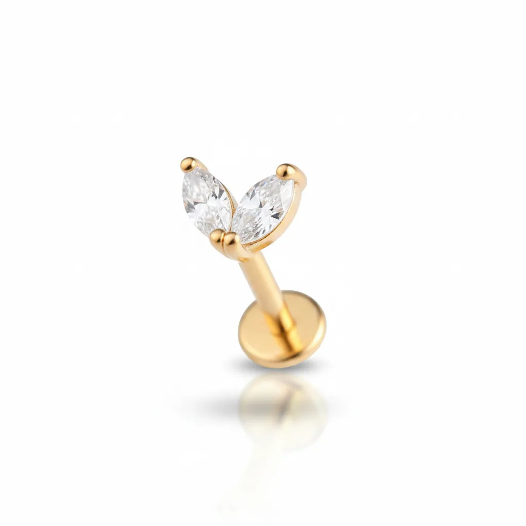 Gold earring with clear gemstones on a white background