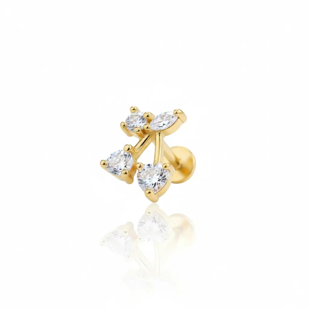 Gold earring with three clear gemstones on a white background