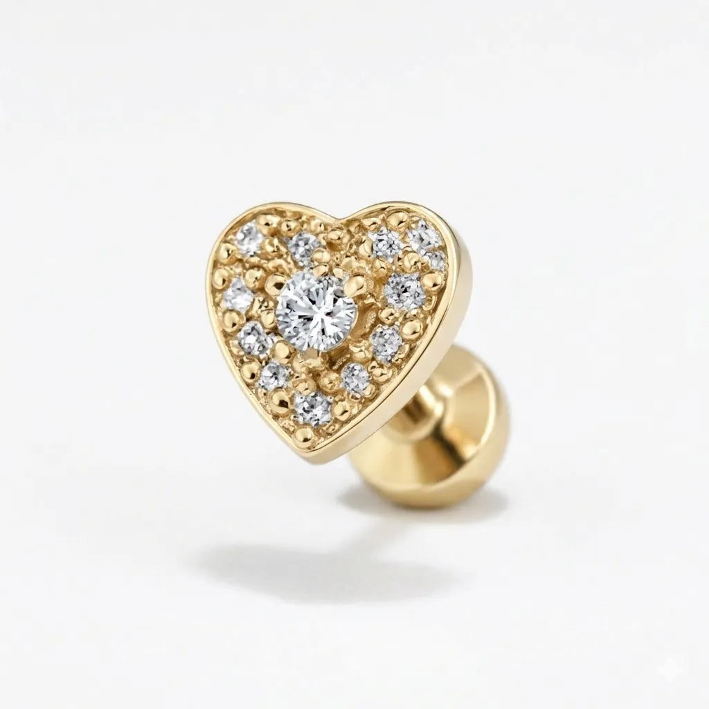 Gold heart-shaped earring with embedded diamonds on a light gray background