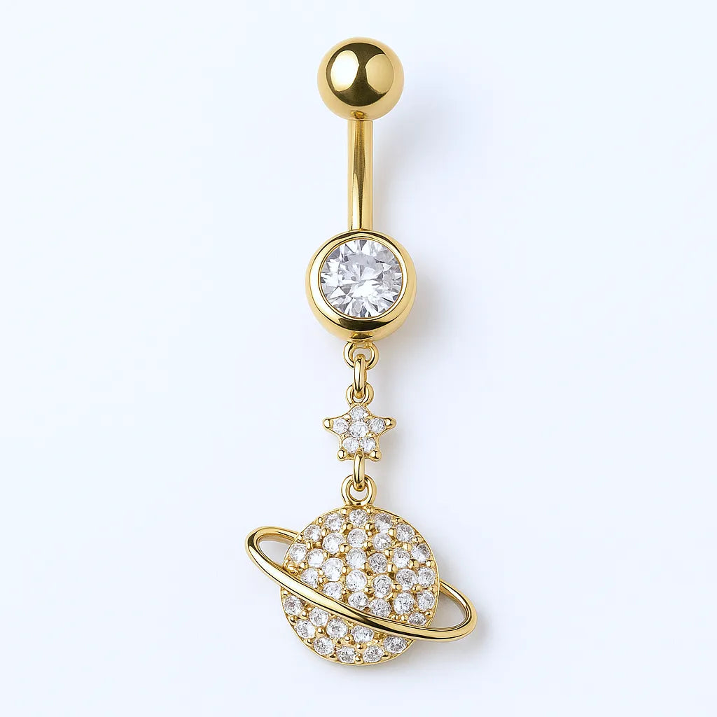 A gold surgical steel belly button piercing with a crystal encrusted saturn design.