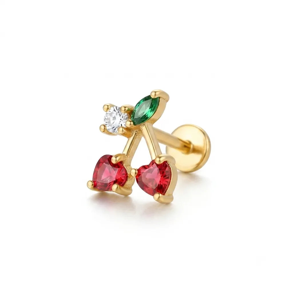 Gold earring with red and green gemstones on a white background