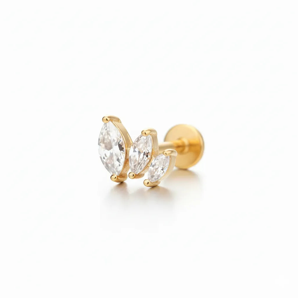 Gold earrings with clear gemstones on a white background