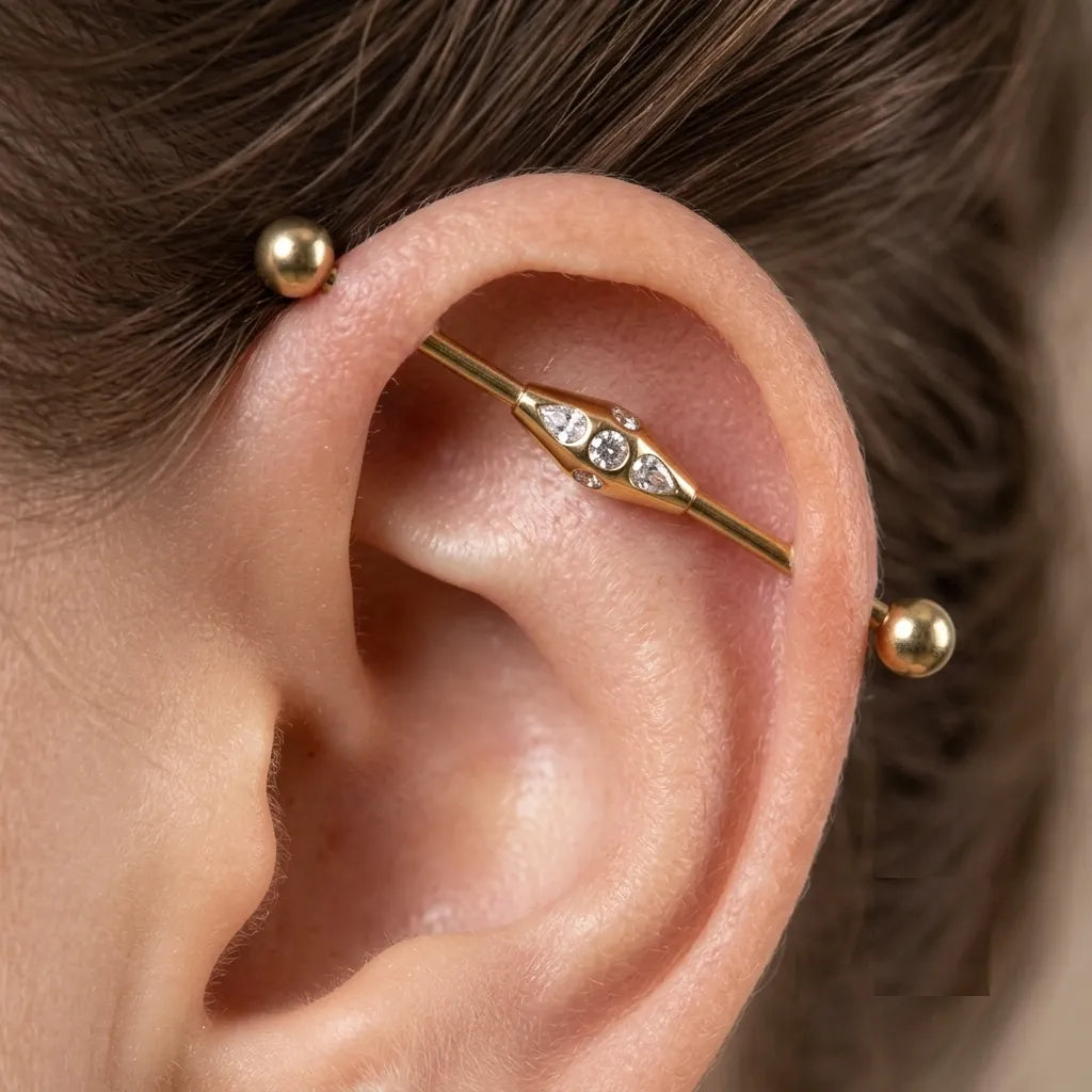 Close-up of an ear with gold earrings and a blurred background