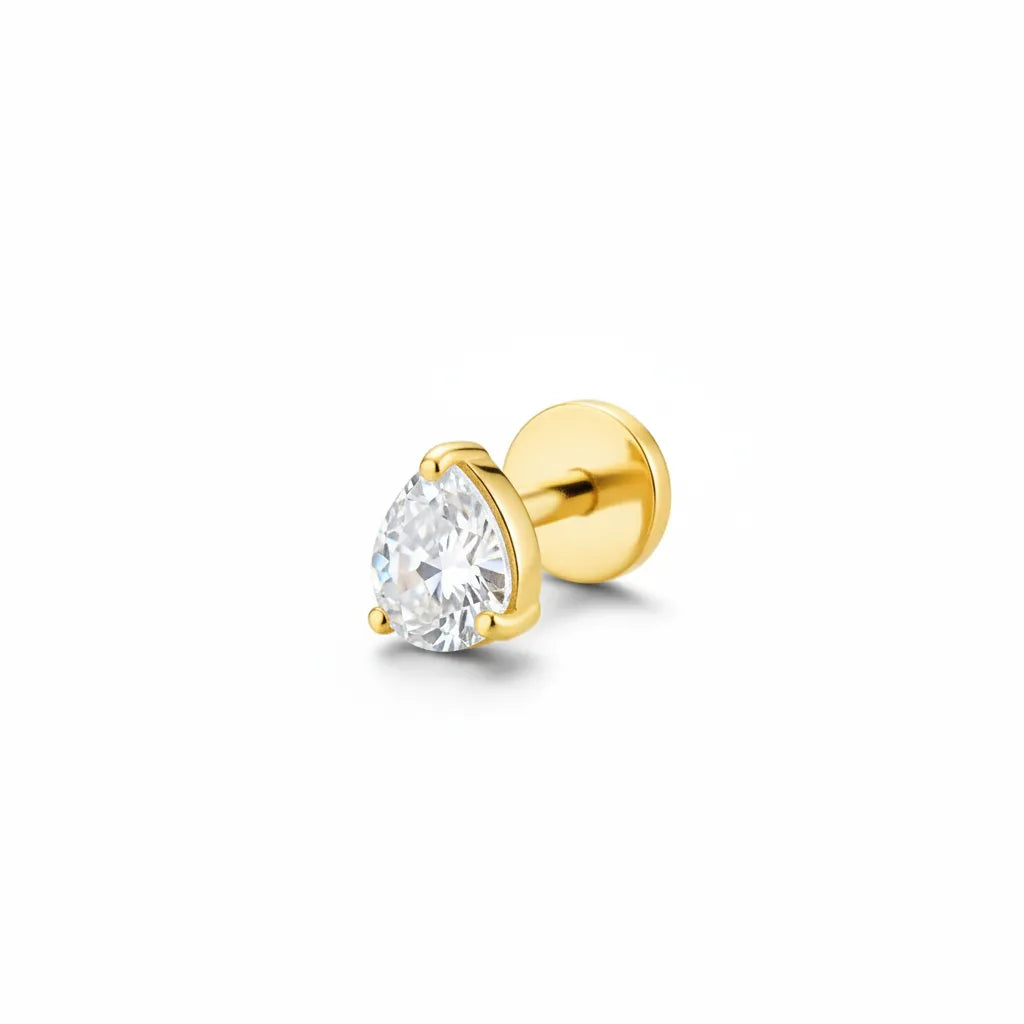 Gold titanium tear drop gem tragus piercing with crystal teardrop top on white background