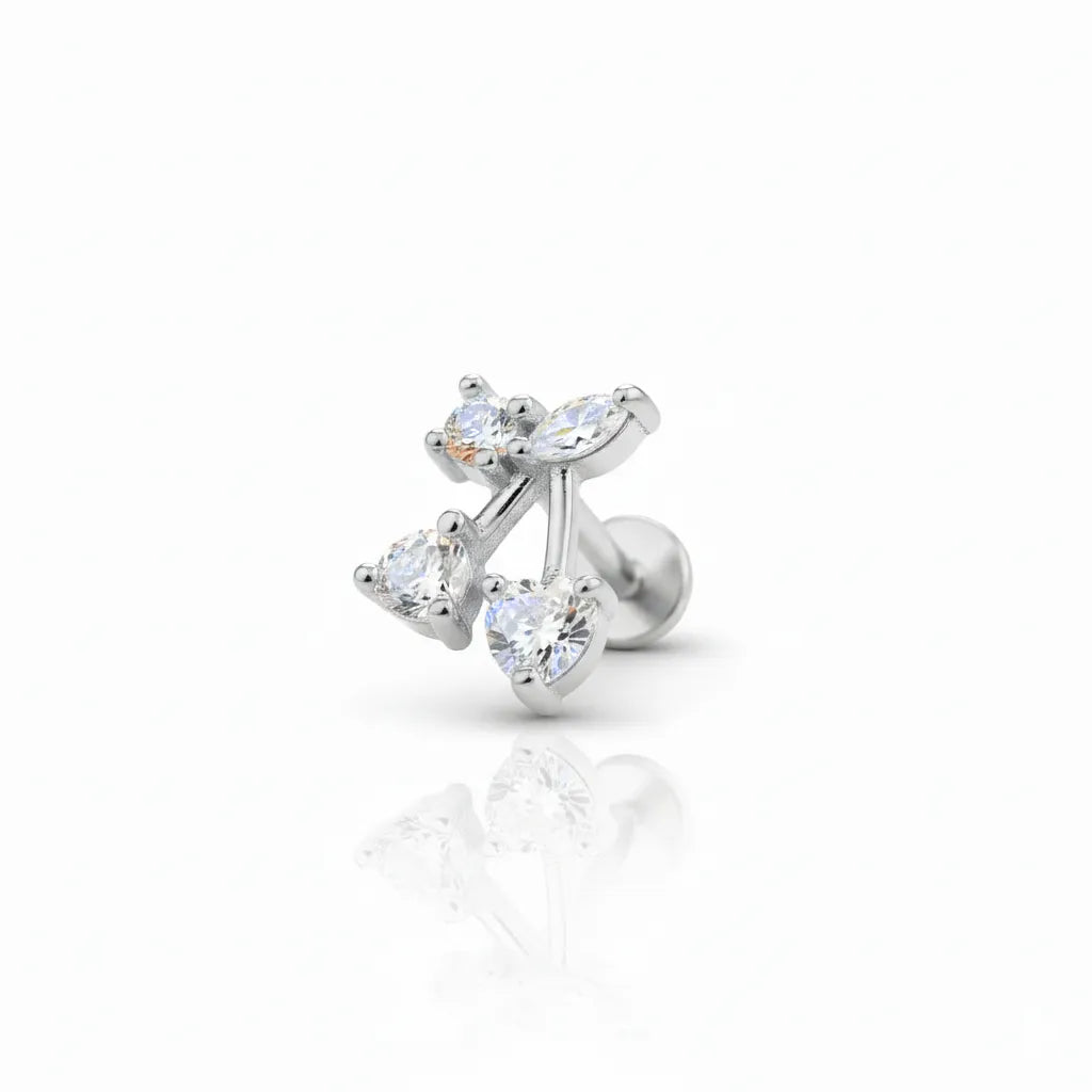 Silver earring with heart-shaped gemstones on a white background