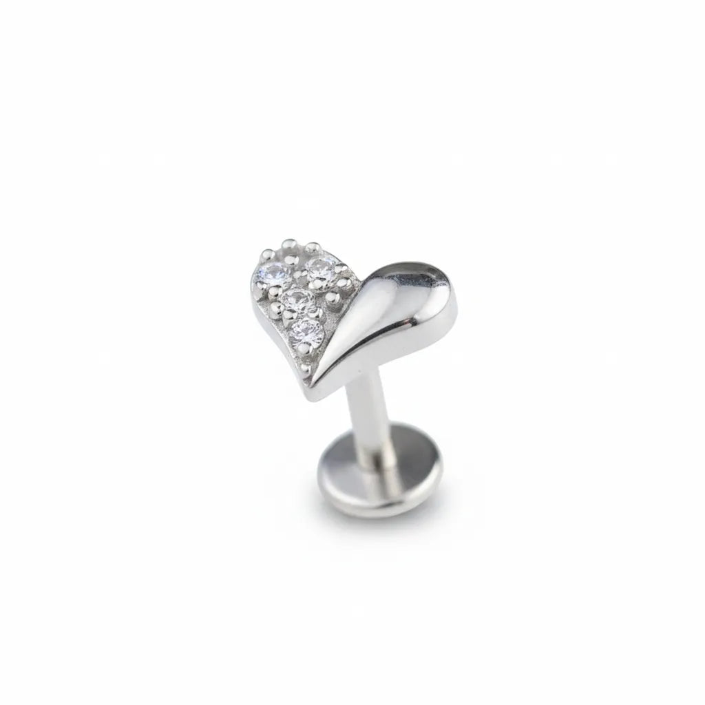 Silver heart-shaped earring with clear gemstone on a white background