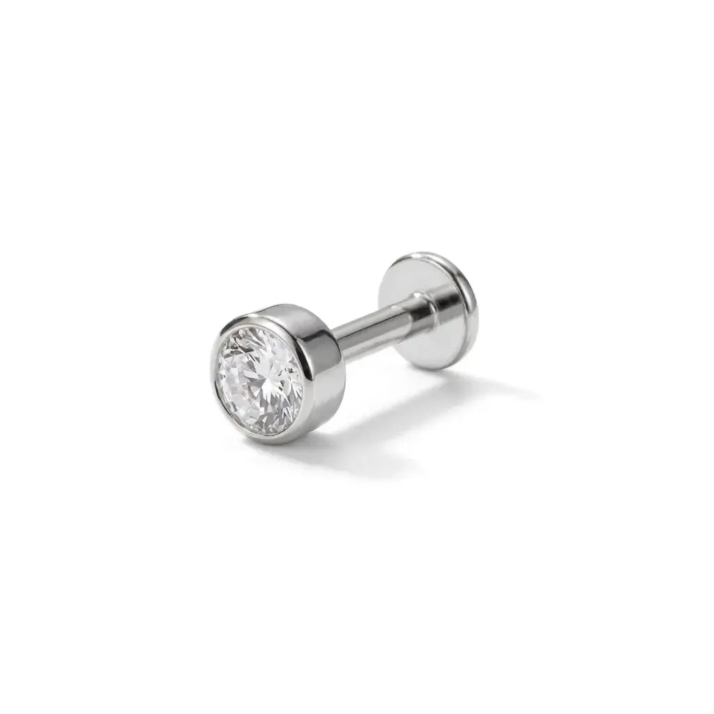 Silver stud earring with a clear gemstone on a white background