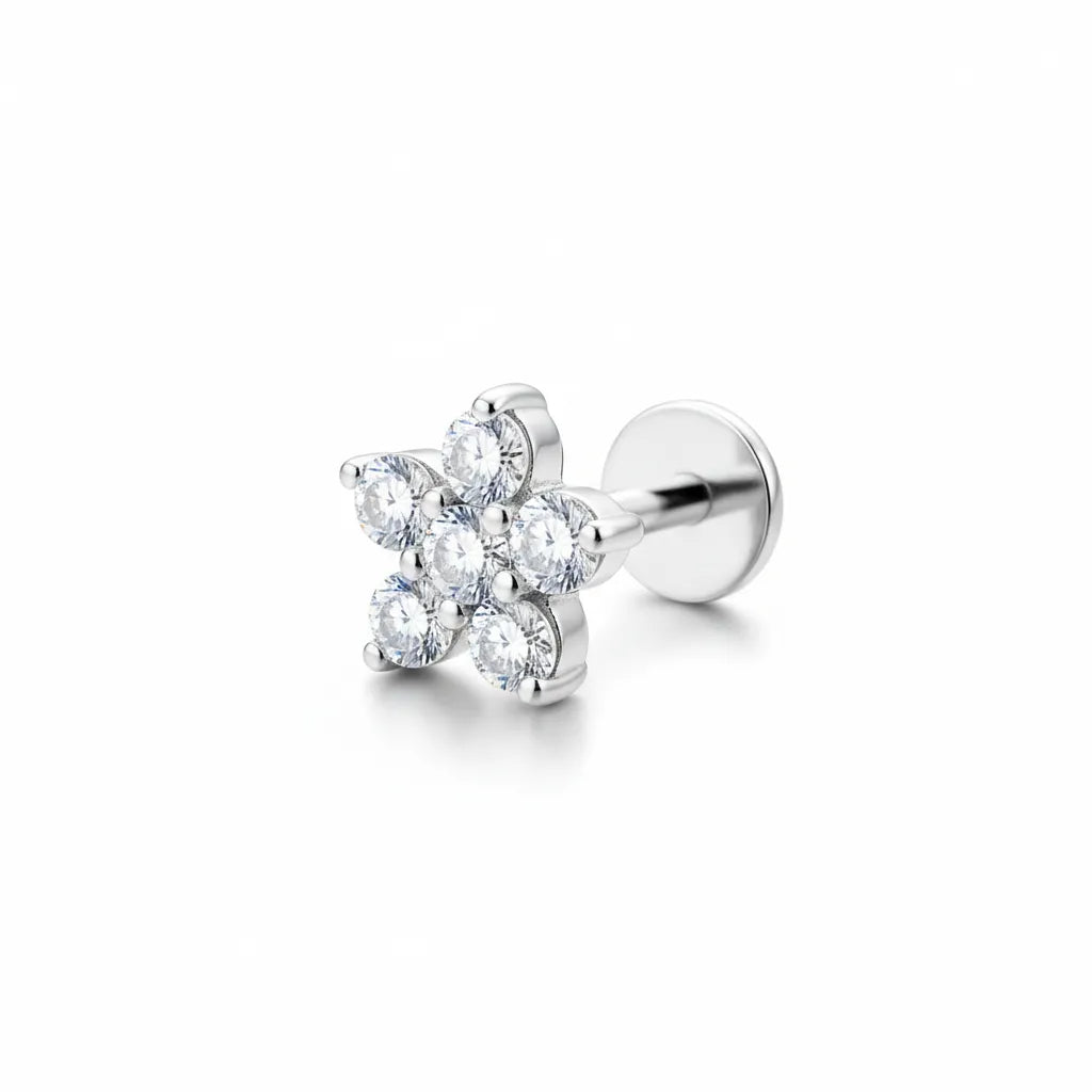 Silver earring with clear gemstones on a white background