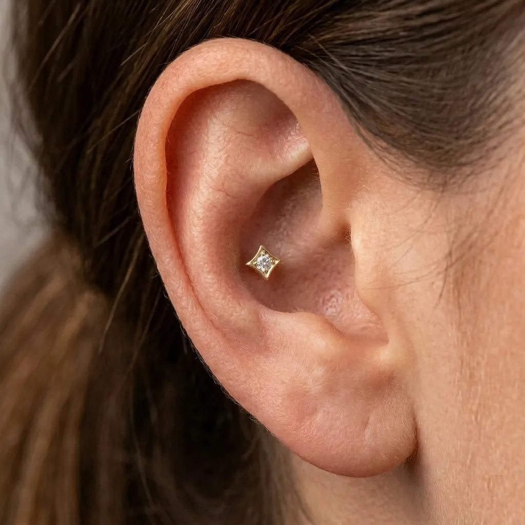 Gold 4-point star CZ flat back labret stud worn in conch piercing