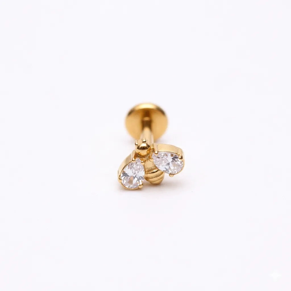 Gold bee-shaped earring with clear gemstones on a white background