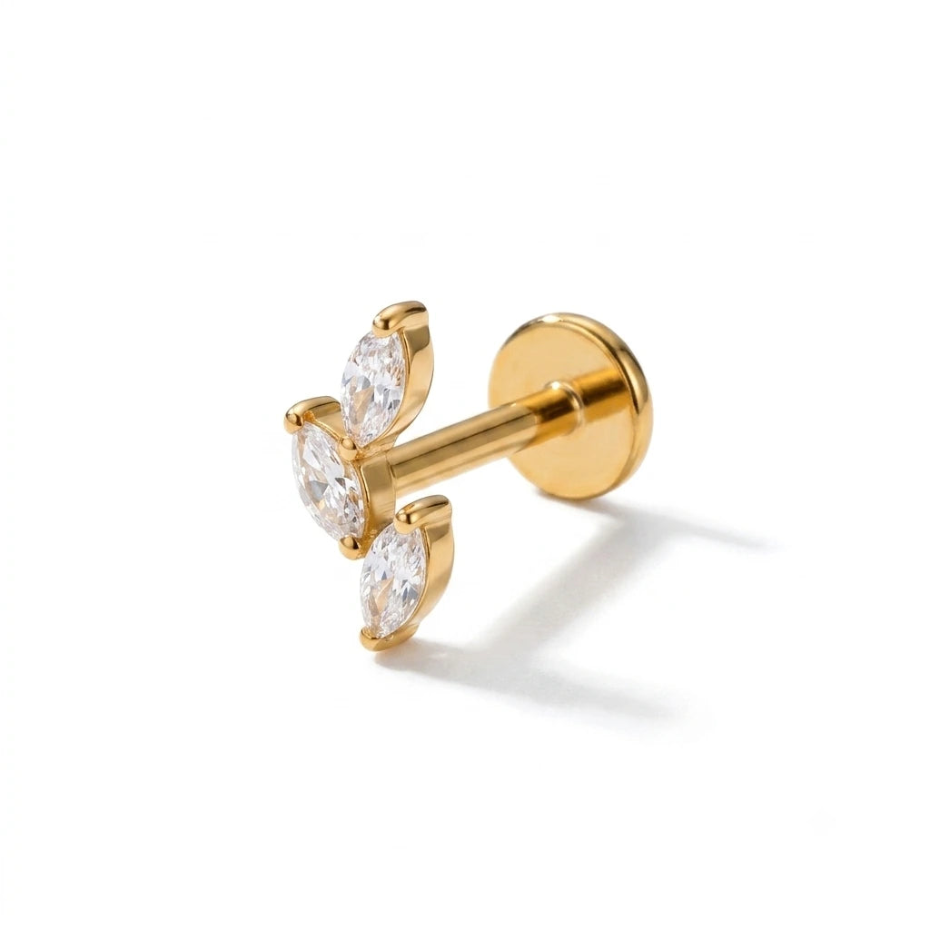 Gold earrings with clear gemstones on a white background