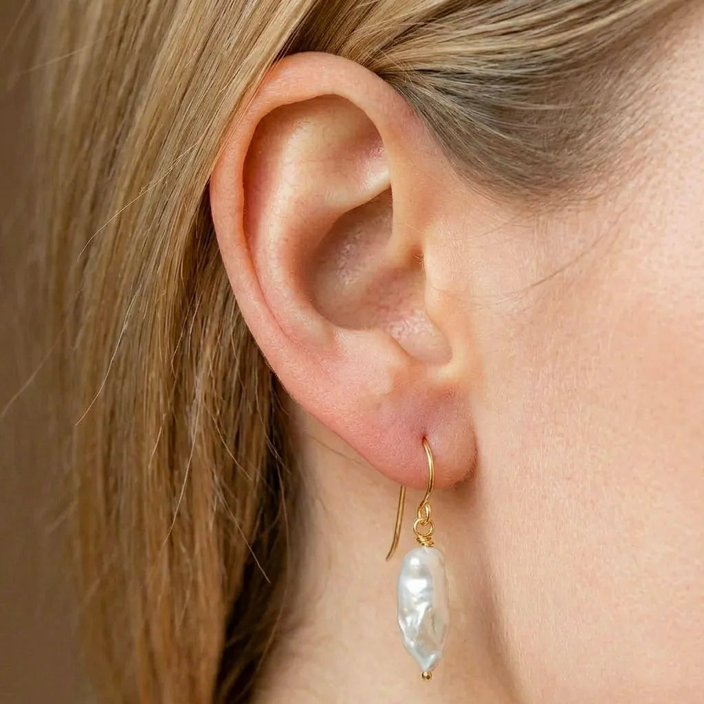 he Perla Opaline gold filled pearl earrings inside a luxury CarlOliver gift box, ready for gifting.