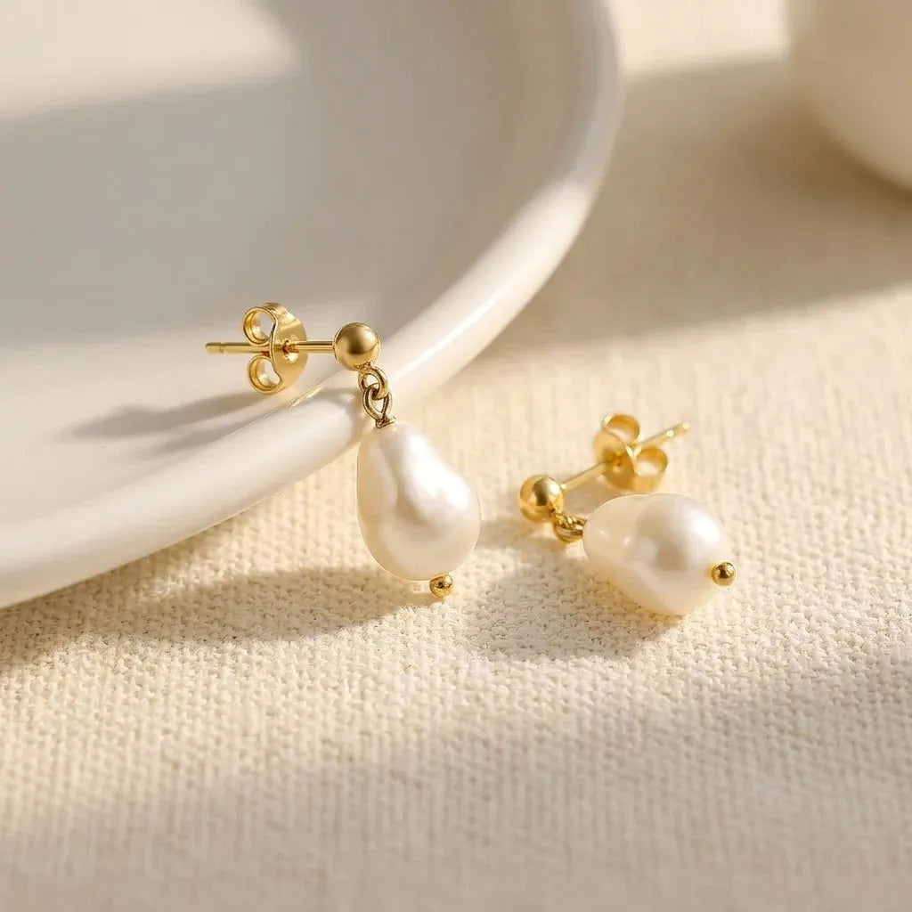 Vita Perlata gold stud double oval freshwater pearl drop earrings on ceramic tray